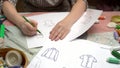 Female designer draw clothes sketch on paper