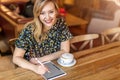 Female designer sketching with digital tablet and stylus at cafe Royalty Free Stock Photo