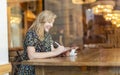 Female designer sketching with digital tablet and stylus at cafe Royalty Free Stock Photo