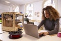 Female Designer Working With 3D Printer In Design Studio