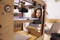 Female Designer Working With 3D Printer In Design Studio