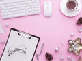 Female desk with blank paper note, keyboard, and Christmas decorations Royalty Free Stock Photo