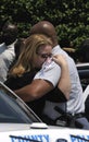 Female detective hug a police officer at a funeral for a fellow police officer