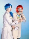 Female detectives investigate a crime. Young women in comic pop art make-up style