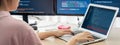 Female developer coding on laptop while computer display program. Burgeoning. Royalty Free Stock Photo