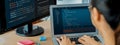 Female developer coding on laptop while computer display program. Burgeoning. Royalty Free Stock Photo
