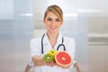 Female dietician holding fruits Royalty Free Stock Photo