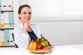 Female dietician showing vegetables and fruit