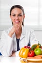 Female dietician showing vegetables and fruit