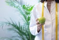Female dietitian in apron and tape measure holding apple Royalty Free Stock Photo