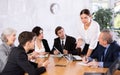 Female director gives instructions to managers in deliberation room