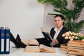 a female director in the office sits at a desk with a book in the office