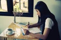 Female director working in coffee shop sitting at desk Royalty Free Stock Photo