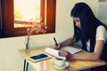 Female director working in coffee shop sitting at desk Royalty Free Stock Photo