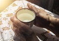 Female dirty hands after hard farm work taking metal white mug with water. Thirsty farmer concept