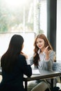 Female discussing new project with male colleague. Mature woman talking with young woman in office Royalty Free Stock Photo