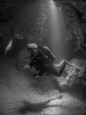 Female diver in cave, Formiche Reef.