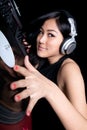Female DJ mixing on turntables Royalty Free Stock Photo