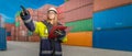 Female docker in protective gear in a container handling area