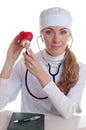 Female docotr examining red heart Royalty Free Stock Photo