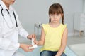 Female doctor applying bandage on little girl`s finger in clinic Royalty Free Stock Photo