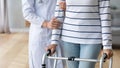 Female doctor assist senior patient with walking frame Royalty Free Stock Photo