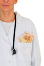 Female doctor with banknotes in the pocket Royalty Free Stock Photo