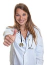 Female doctor with blond hair showing thumb Royalty Free Stock Photo