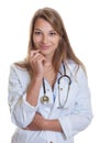 Female doctor with blond hair smiling at camera Royalty Free Stock Photo