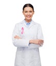 Female doctor with breast cancer awareness ribbon Royalty Free Stock Photo