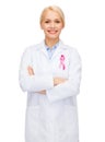 Female doctor with breast cancer awareness ribbon Royalty Free Stock Photo