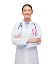 Female doctor with breast cancer awareness ribbon Royalty Free Stock Photo