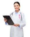 Female doctor with breast cancer awareness ribbon Royalty Free Stock Photo