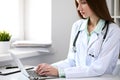 Female doctor brunette sitting at the table near the window in hospital Royalty Free Stock Photo