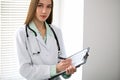 Female doctor brunette sitting at the table near the window in hospital Royalty Free Stock Photo