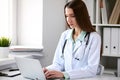 Female doctor brunette sitting at the table near the window in hospital Royalty Free Stock Photo