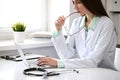 Female doctor brunette sitting at the table near the window in hospital Royalty Free Stock Photo