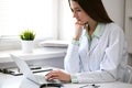 Female doctor brunette sitting at the table near the window in hospital Royalty Free Stock Photo