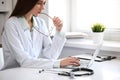 Female doctor brunette sitting at the table near the window in hospital Royalty Free Stock Photo