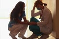 A female doctor calms down a tired colleague