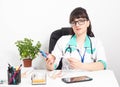 Female doctor cardiologist with a mock heart in hands in a doctor\'s office. The concept of treatment and heart surgery