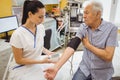 Female doctor checking blood pressure of patient Royalty Free Stock Photo