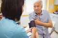 Female doctor checking blood pressure of patient Royalty Free Stock Photo