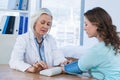 Female doctor checking blood pressure of a patient Royalty Free Stock Photo