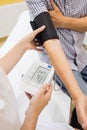 Female doctor checking blood pressure of patient Royalty Free Stock Photo