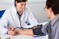 Female Doctor Checking Blood Pressure Of Patient Royalty Free Stock Photo