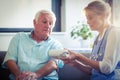 Female doctor checking blood pressure of senior man Royalty Free Stock Photo