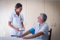 Female doctor checking blood pressure of senior man Royalty Free Stock Photo