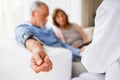 Female doctor checking blood pressure of senior man. Royalty Free Stock Photo