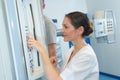Female doctor checking hospital board Royalty Free Stock Photo